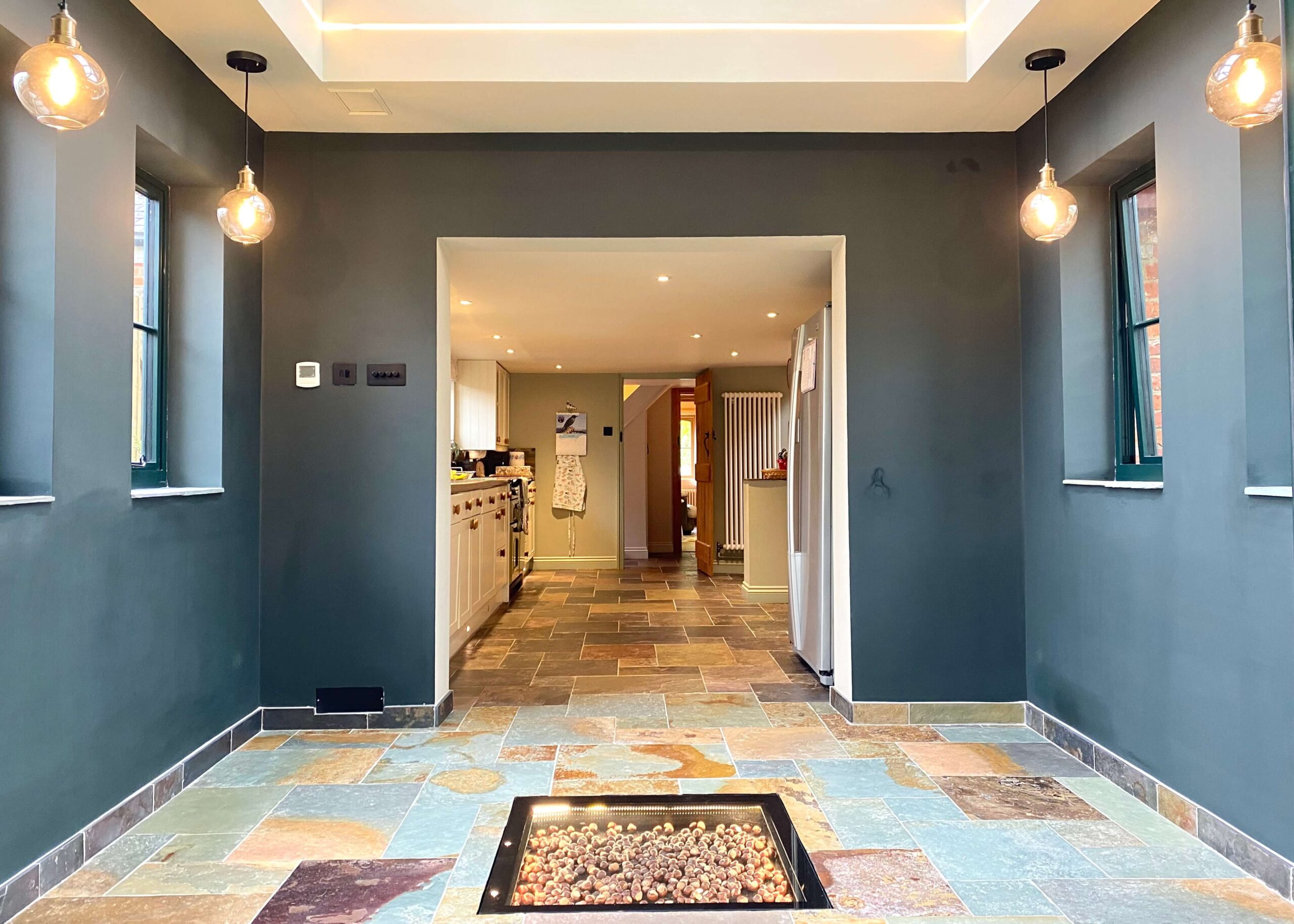 A blue/grey themed house extension interior with stone finishing