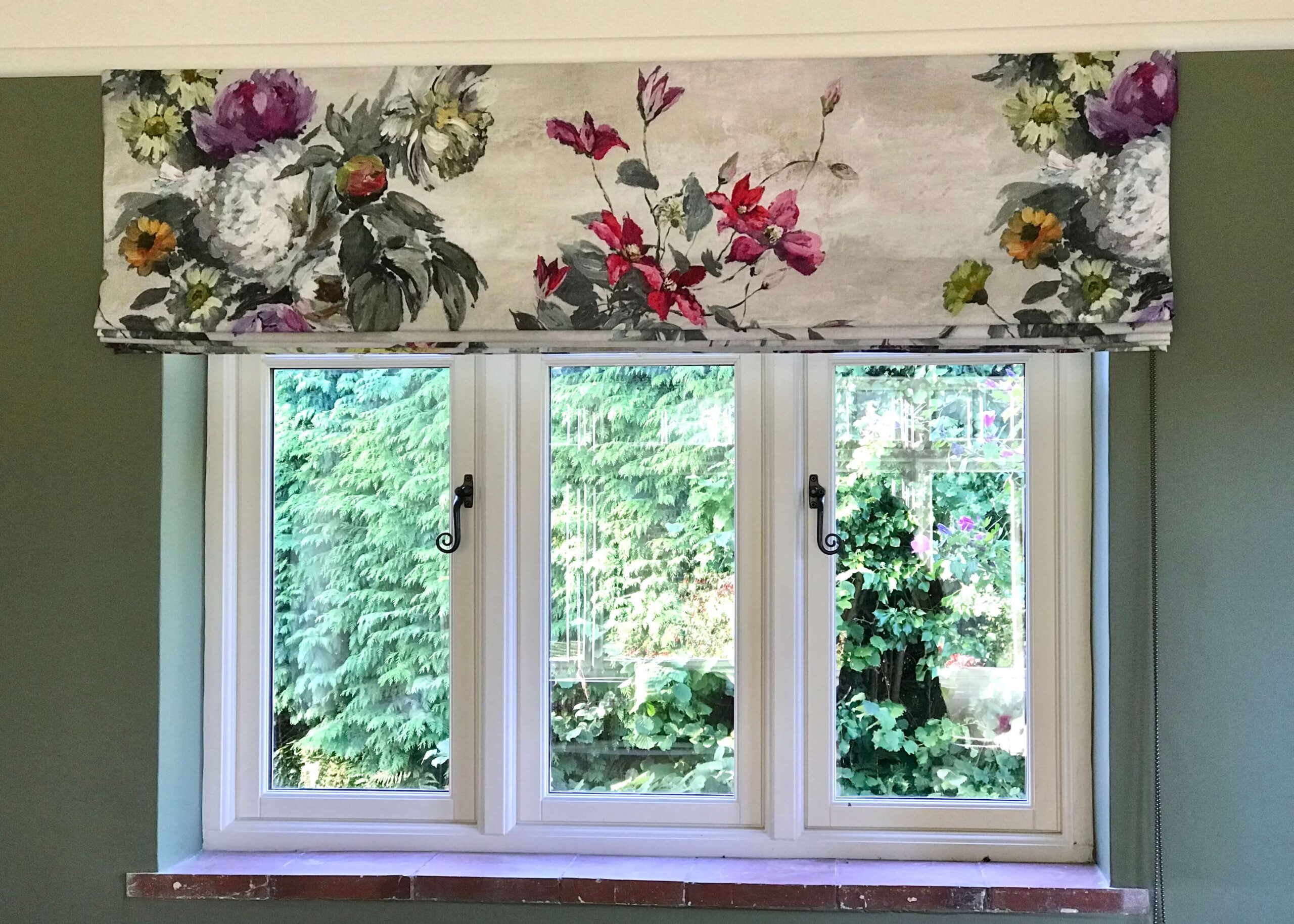 Floral Roman blind against a window