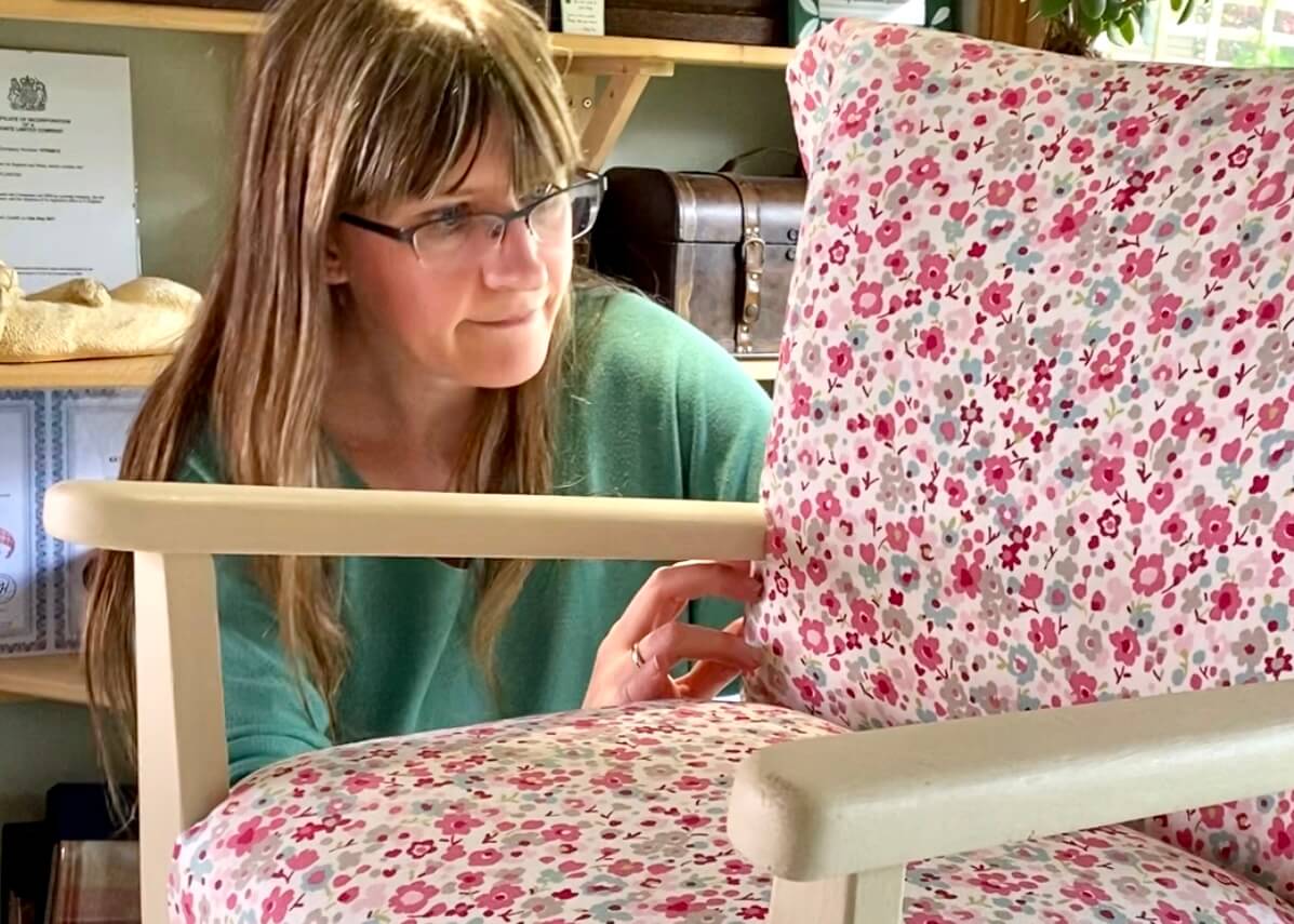 Woman upholstering a chair