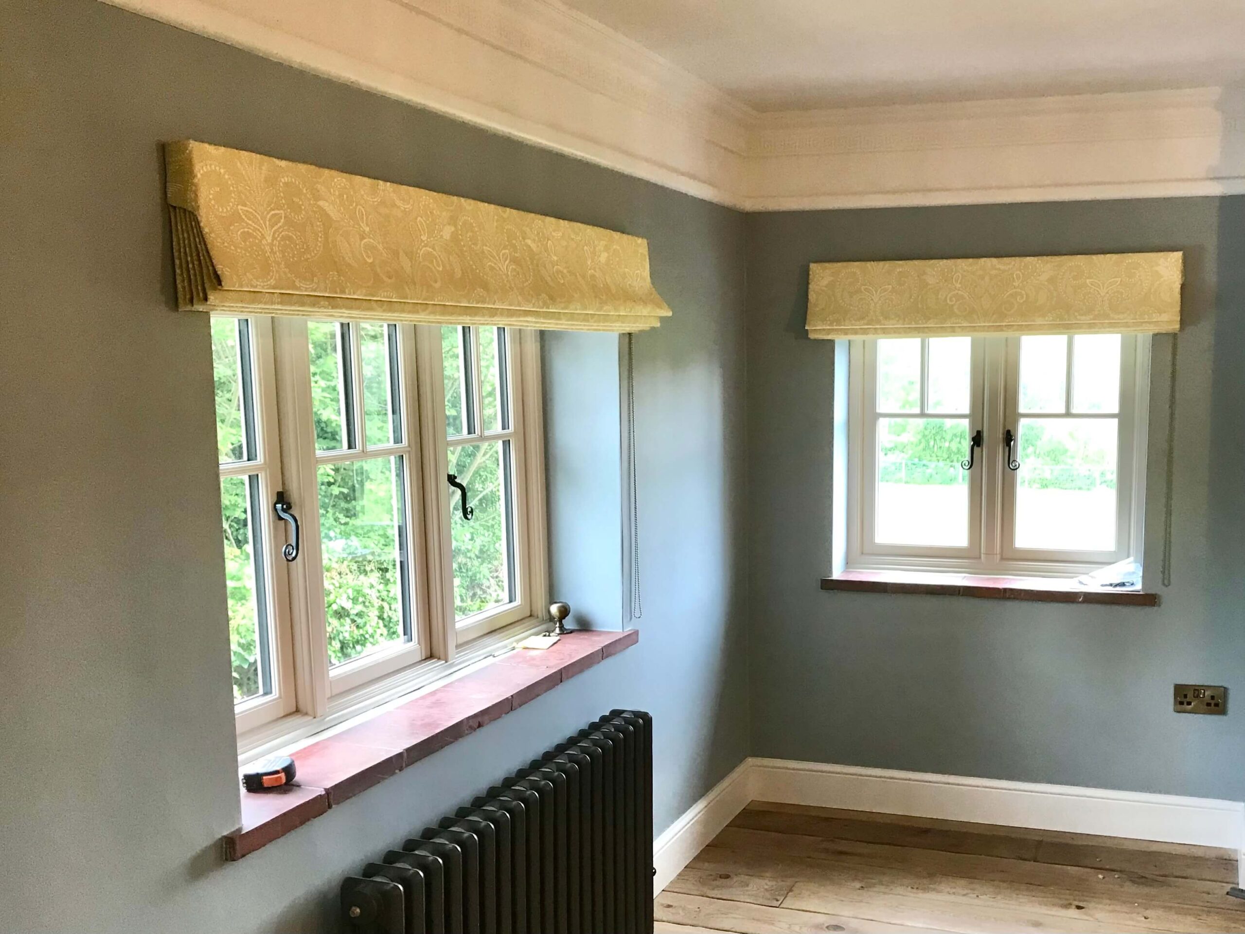 An empty room with Roman blinds 