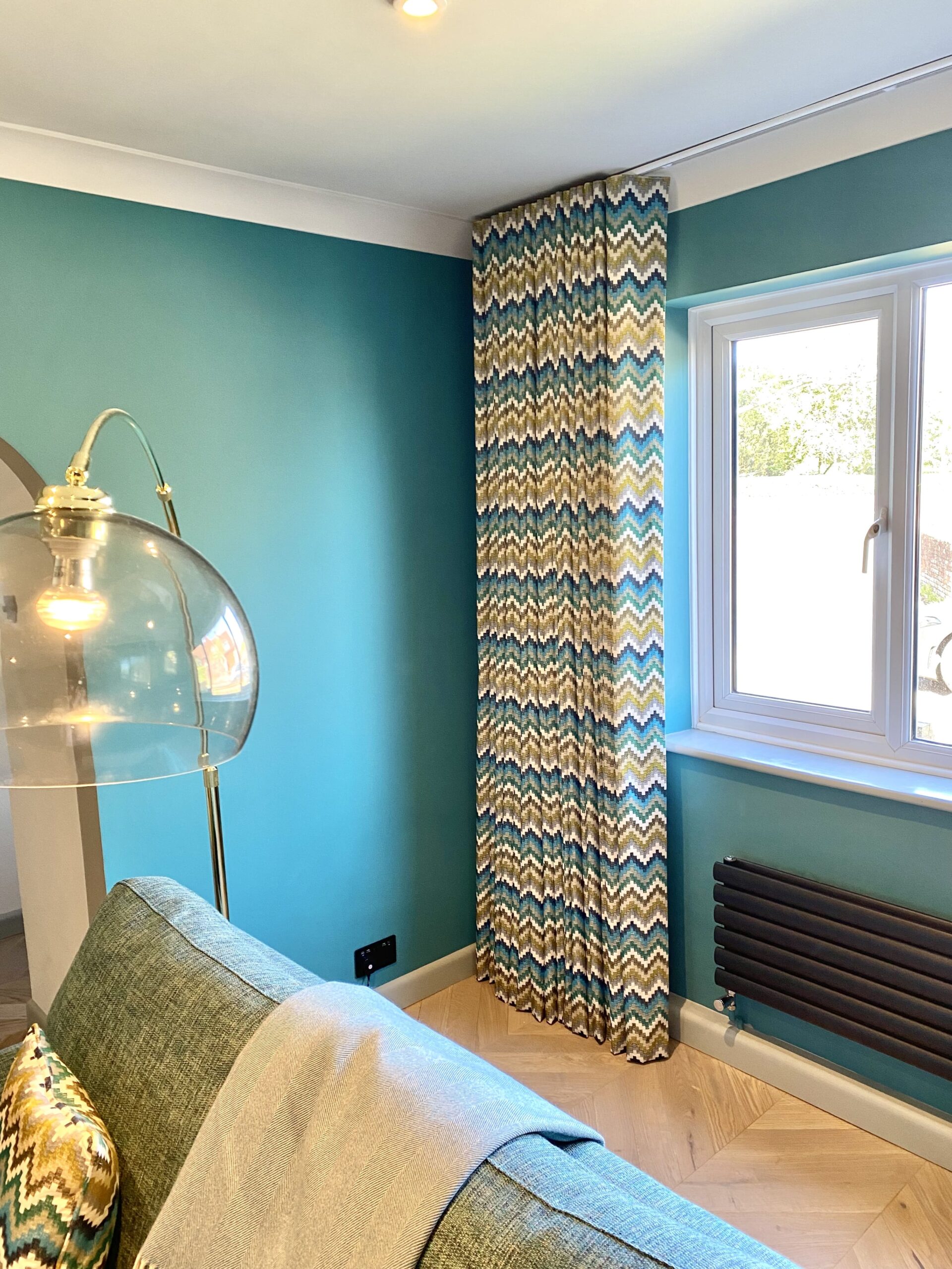 Patterned curtains in a blue toned room