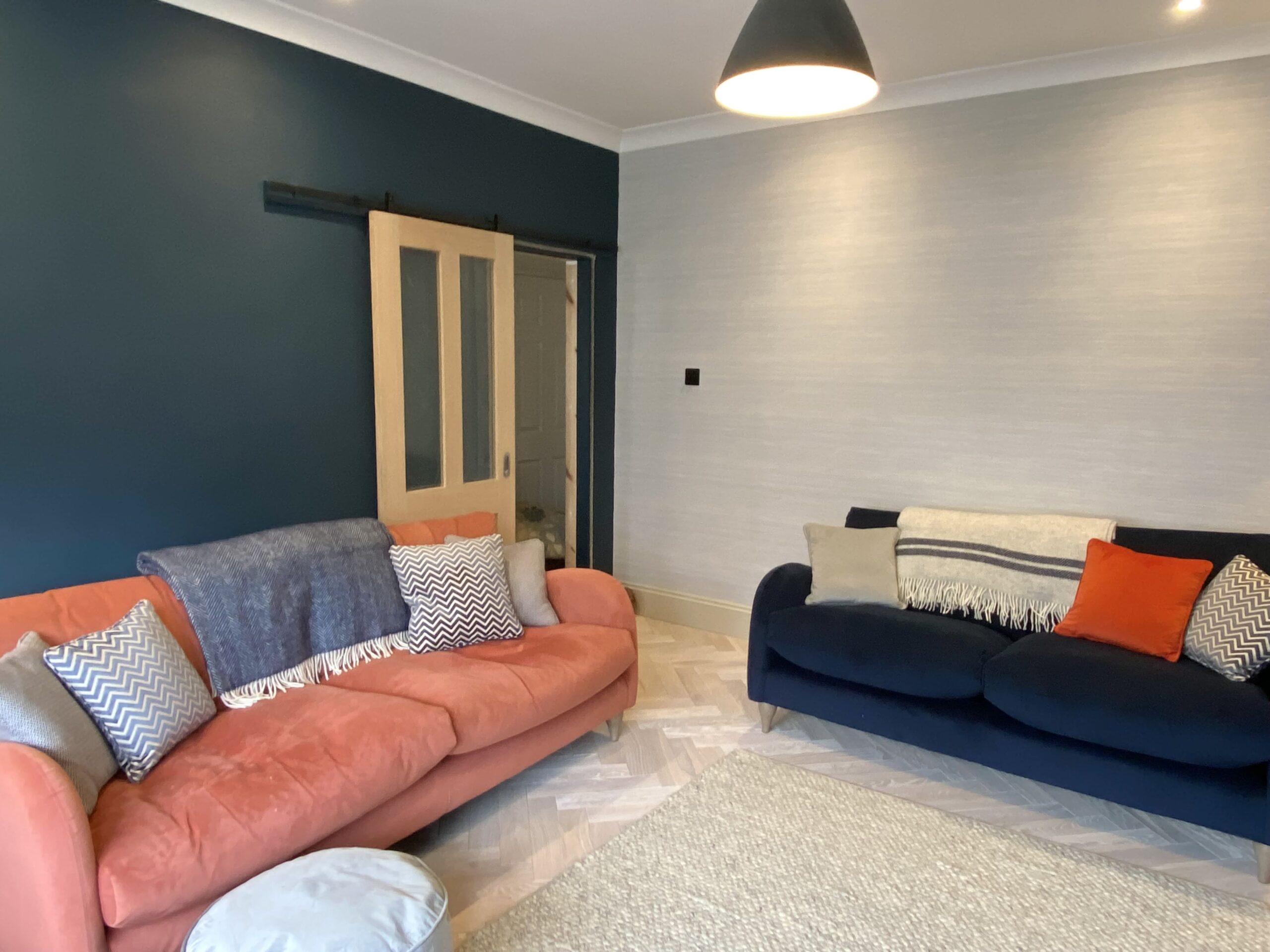 Orange and blue sofas in front of a door 