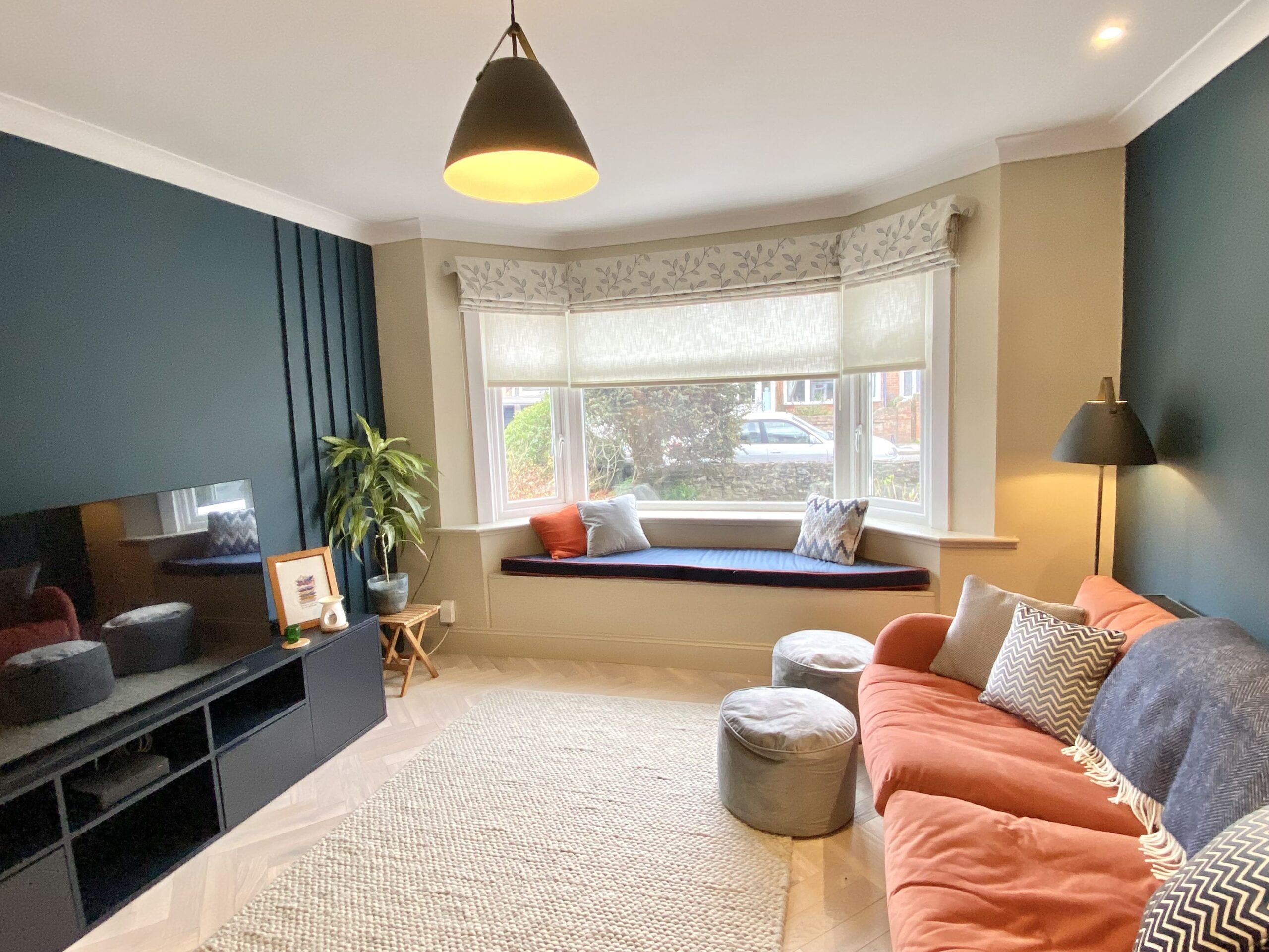 Orange and blue toned sitting room with window seat 