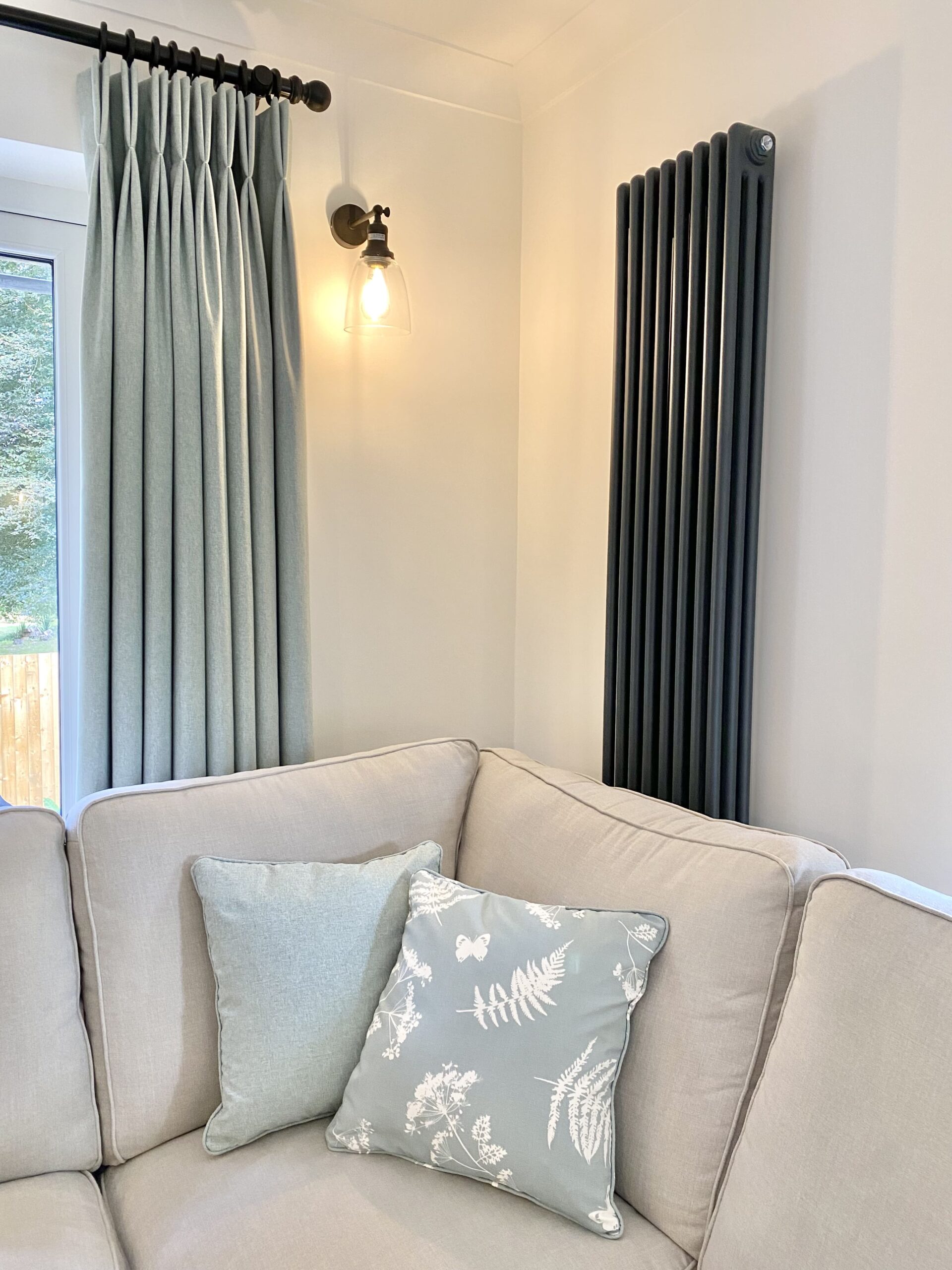 Close up of pattered cushions and blue curtains 