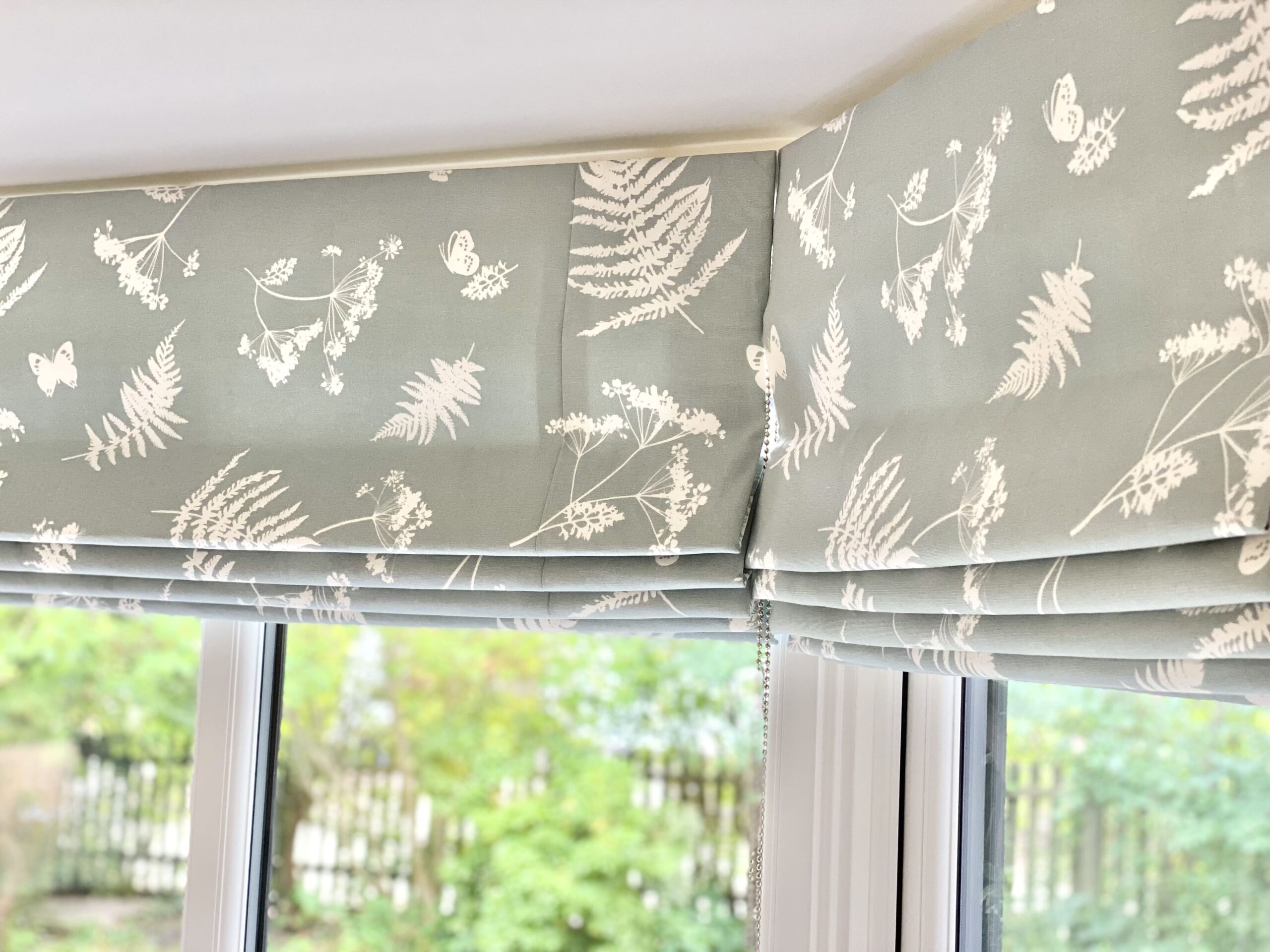 Close up of a patterned Roman blind 