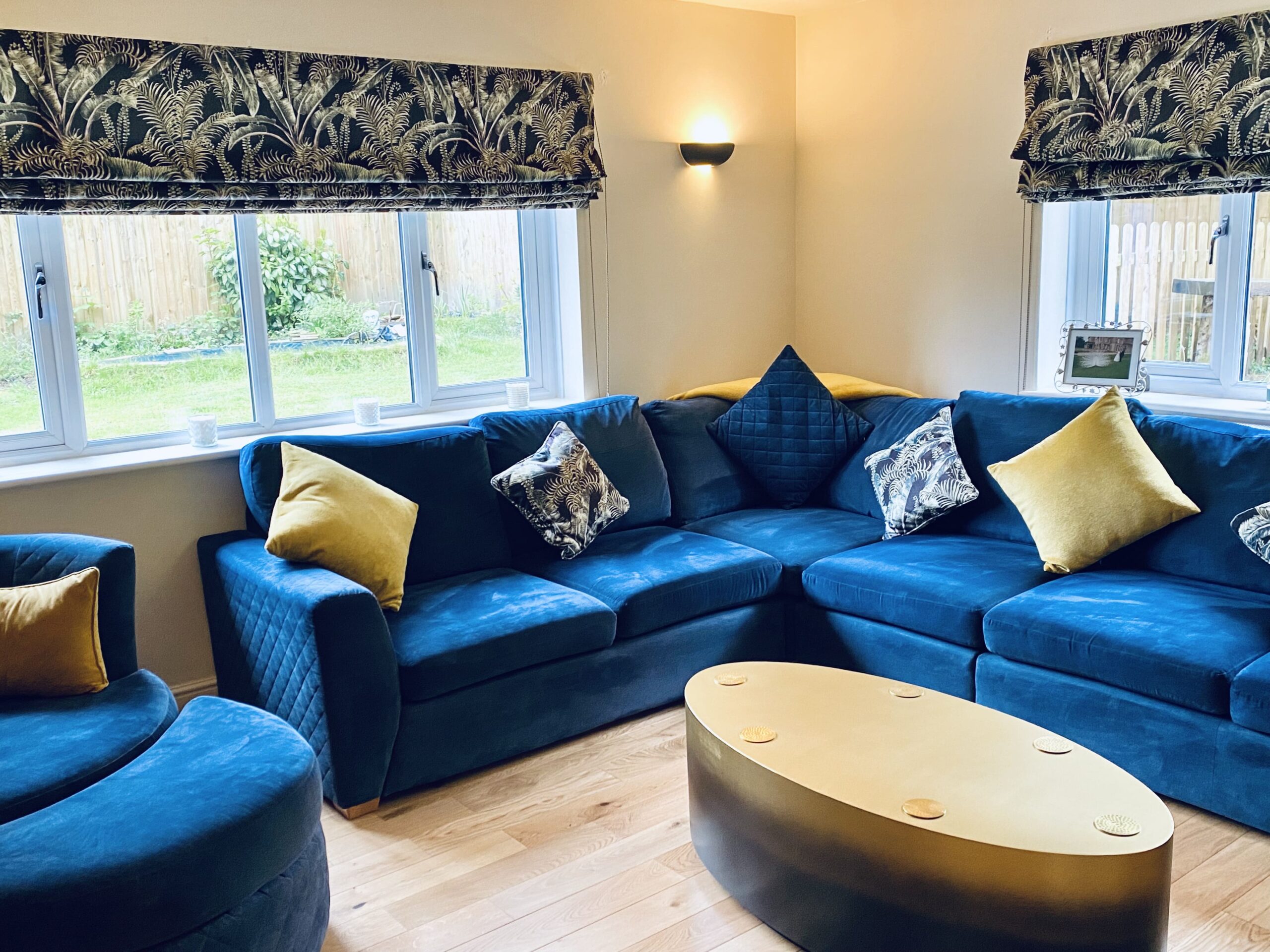 Blue and gold toned sitting room with sofa and table 