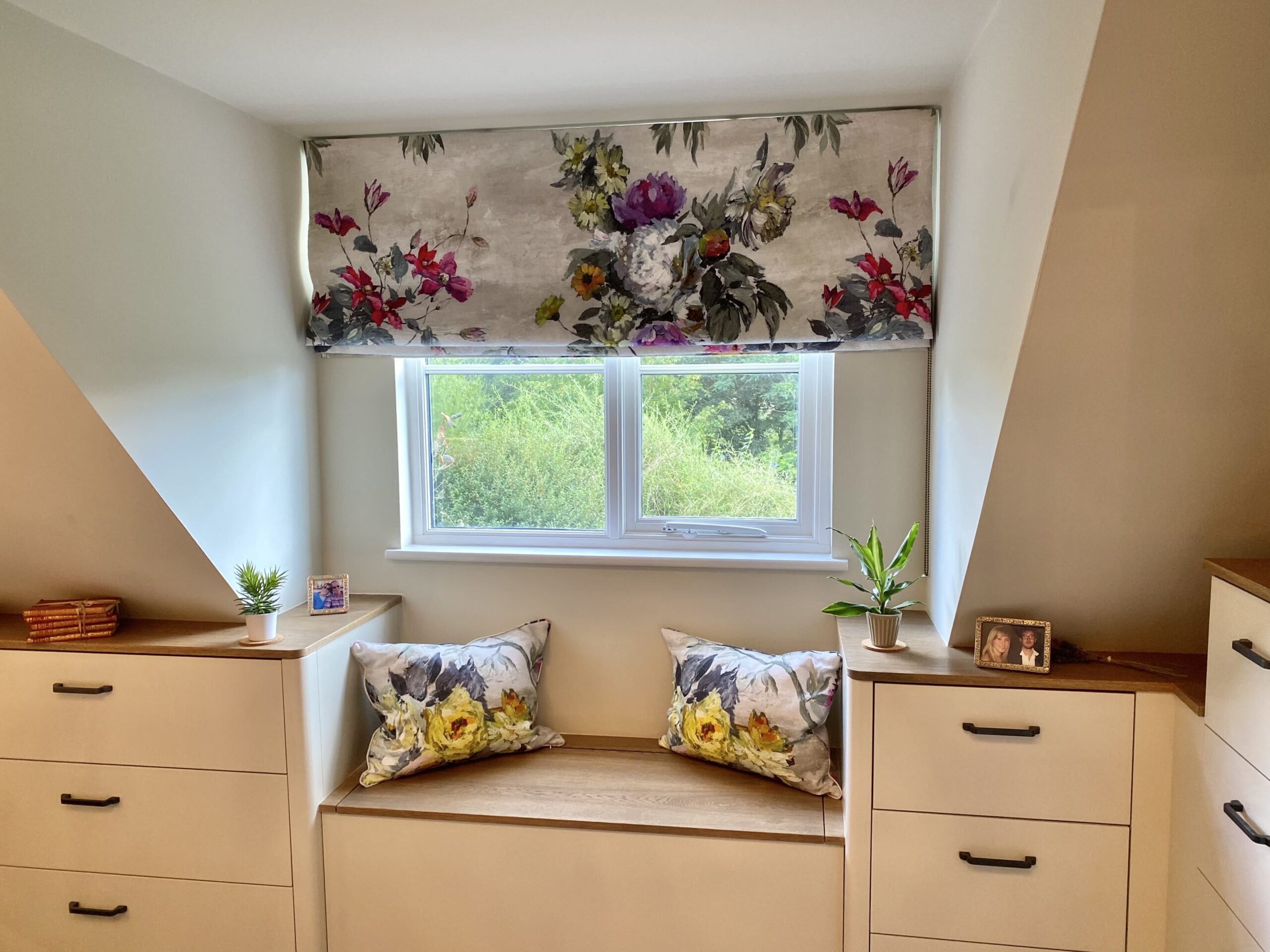 A window seat with floral accents 